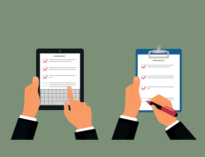 Businessman using tablet pc and notepad with task list